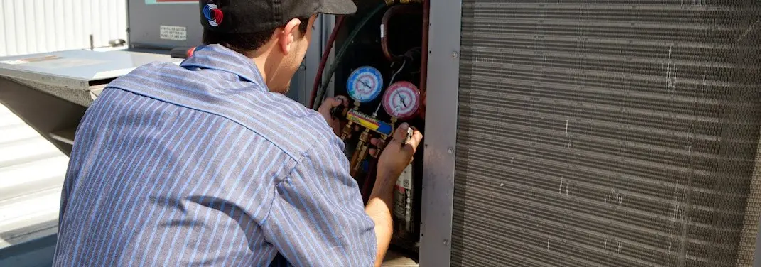 HVAC technician servicing a condenser unit in Nolensville
