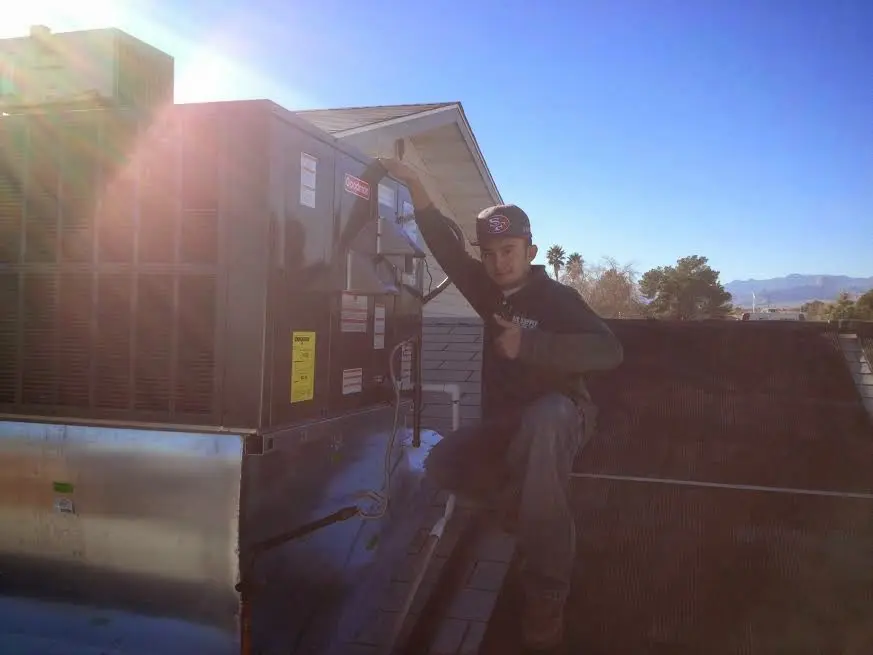 HVAC technician performing Boiler Repair on a rooftop unit in Nolensville